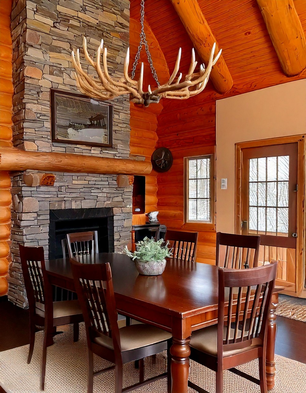 Log Cabin Dining Area With Wooden Beams And Antler Chandelier